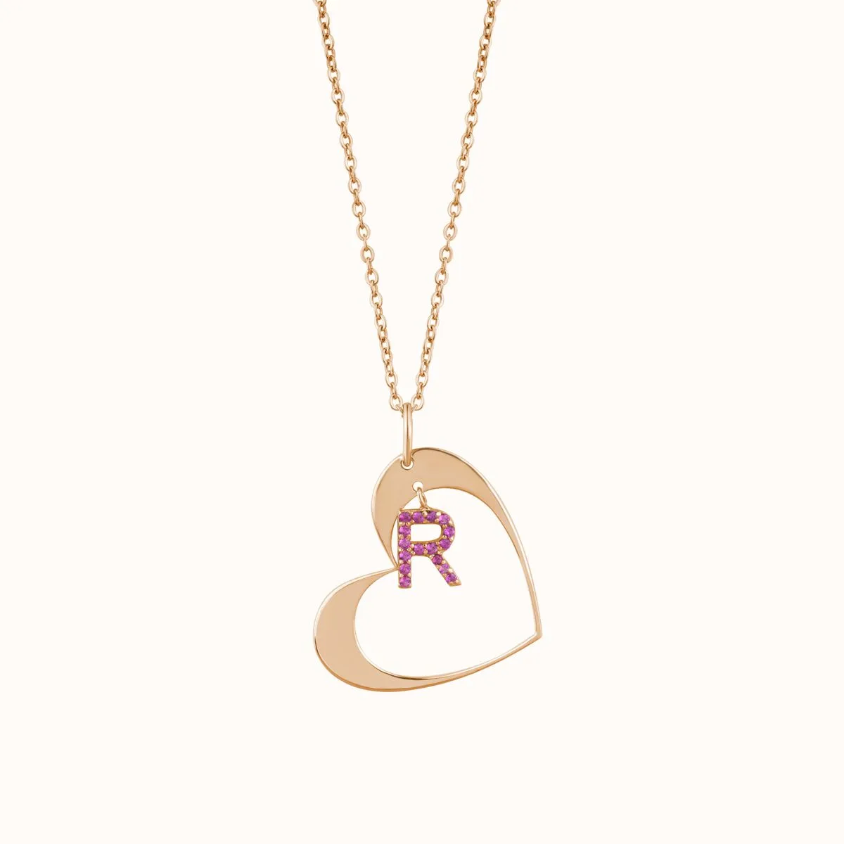Rose-gold layering chain with a heart pendant set with pink gemstones